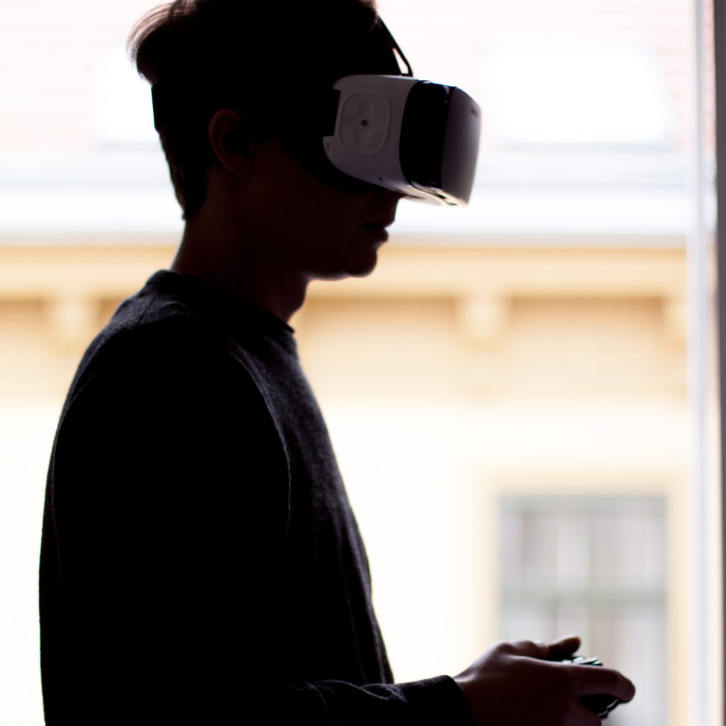 Image of a guy using a gamepad to control the VR device